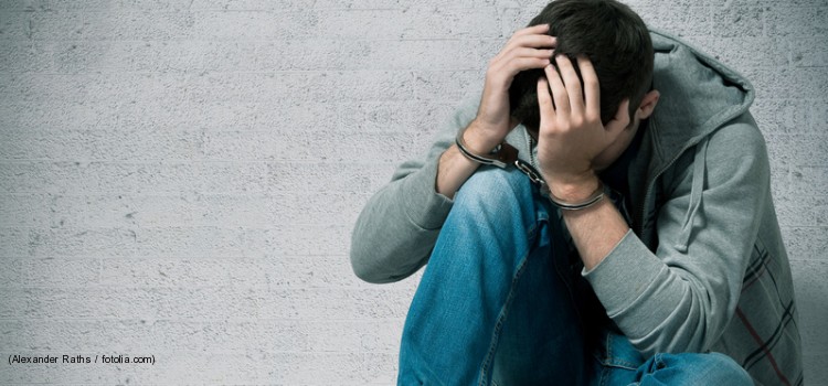 Arrested teenager with handcuffs on his hands