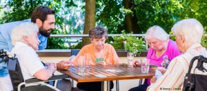 Gruppe von Seniorinnen spielt Karten.