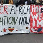 protest banners "Homophobia is a Western Import" und "Queer African Liberation Now"