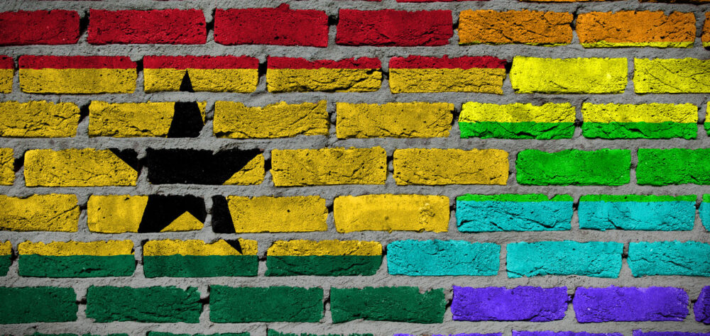 Dark brick wall texture - coutry flag and rainbow flag painted on wall - Ghana
