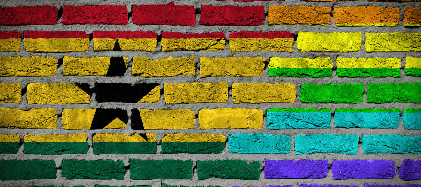 Dark brick wall texture - coutry flag and rainbow flag painted on wall - Ghana
