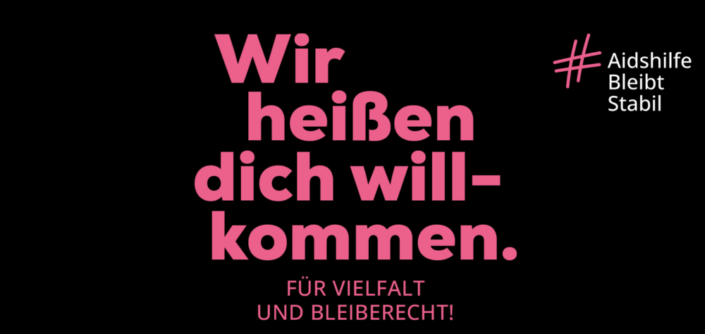 Blaue Schrift auf schwarzen Hintergrund: Wir heiße dich willkommen. Für Vielfalt und Bleiberecht! Hashtag Aidshilfe Bleibt Stabil. Deutsche Aidshilfe